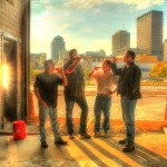 Warped Wing Brewing Partners in the brewery with downtown Dayton in the background 09/30/2013, left to right:Joe Waizmann,  Nick Bowman, Mike Stover.John Haggerty, Photo courtesy of WWBC, Inc.